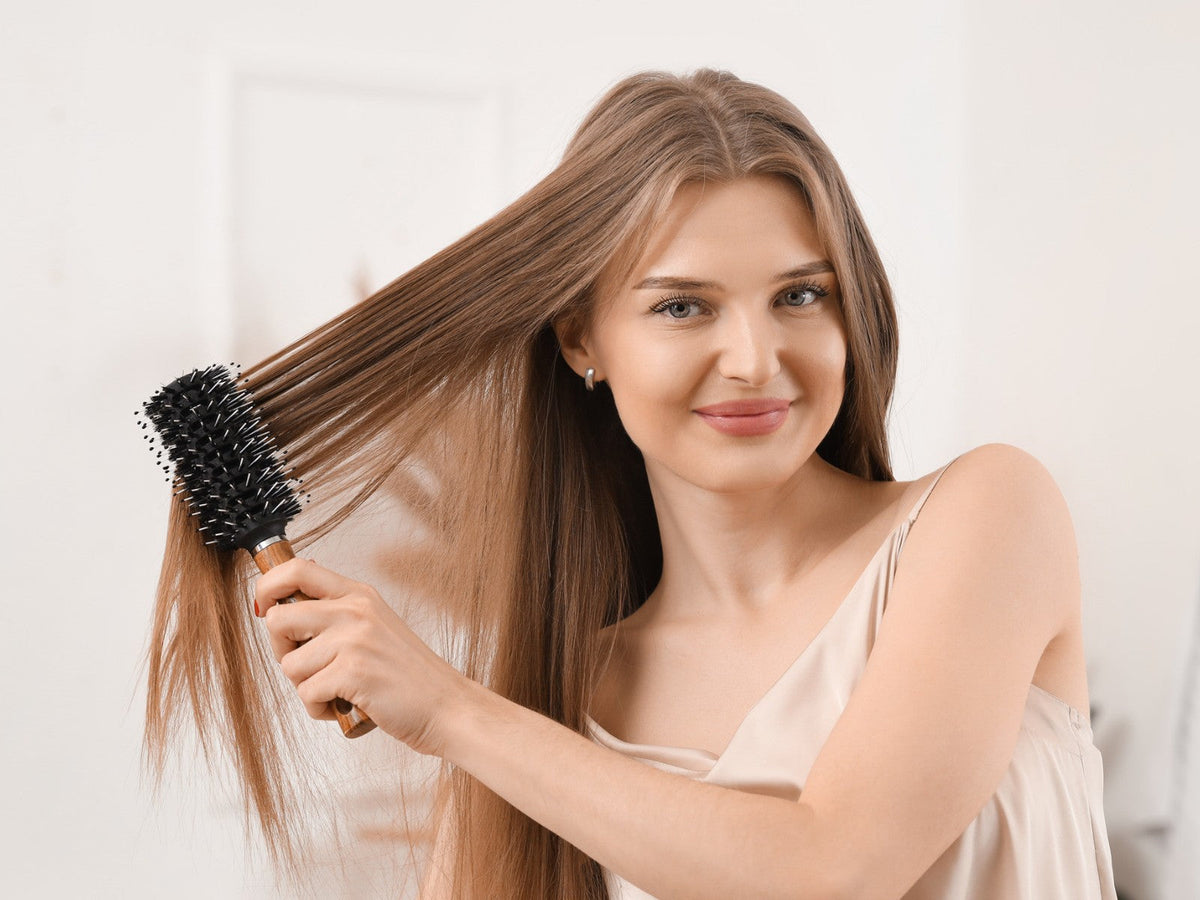 Woman brushing through the lengths of her hair