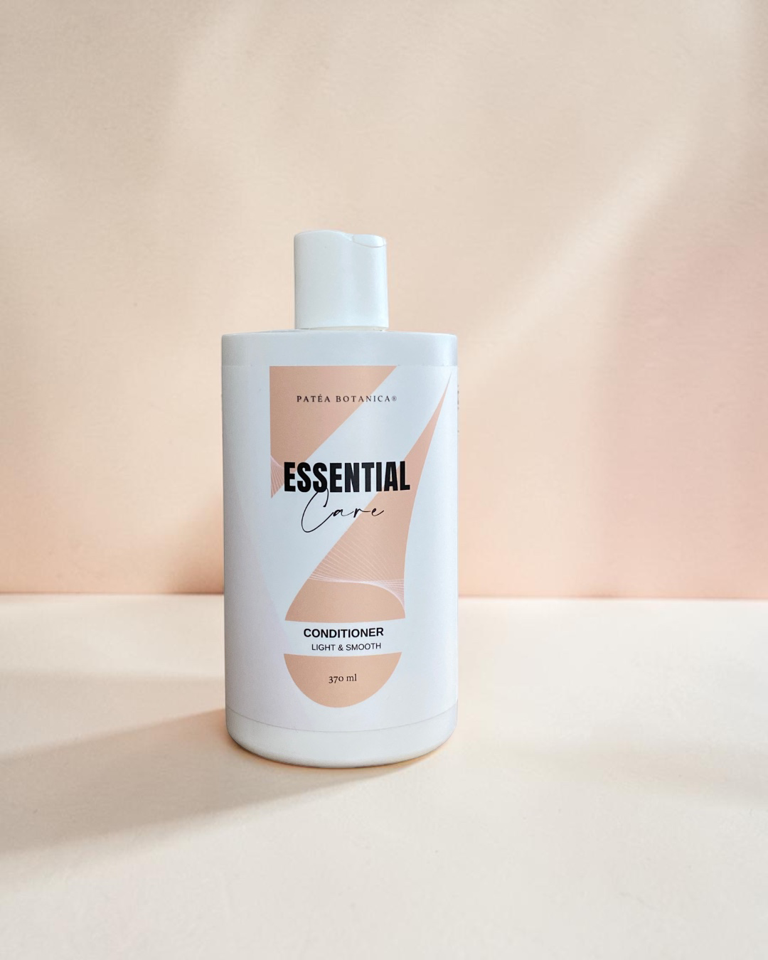 Bottle of Patea Botanica  'Essential Care' conditioner on a beige background