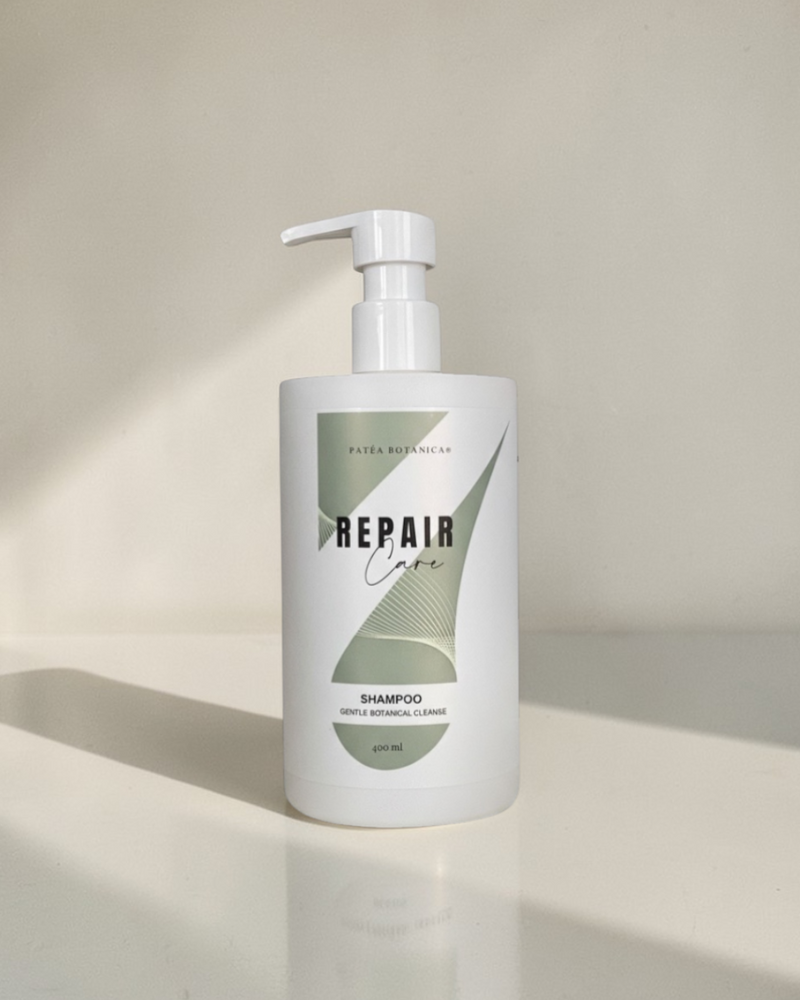 Shampoo bottle labeled 'Repair' on a neutral background