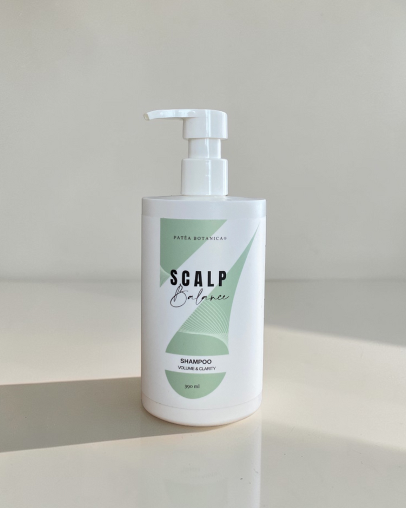 Bottle of Scalp Balance shampoo on a white background