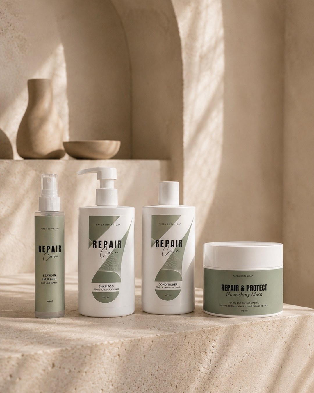 Set of Patea Botanica haircare products including bottles and a jar on a neutral background