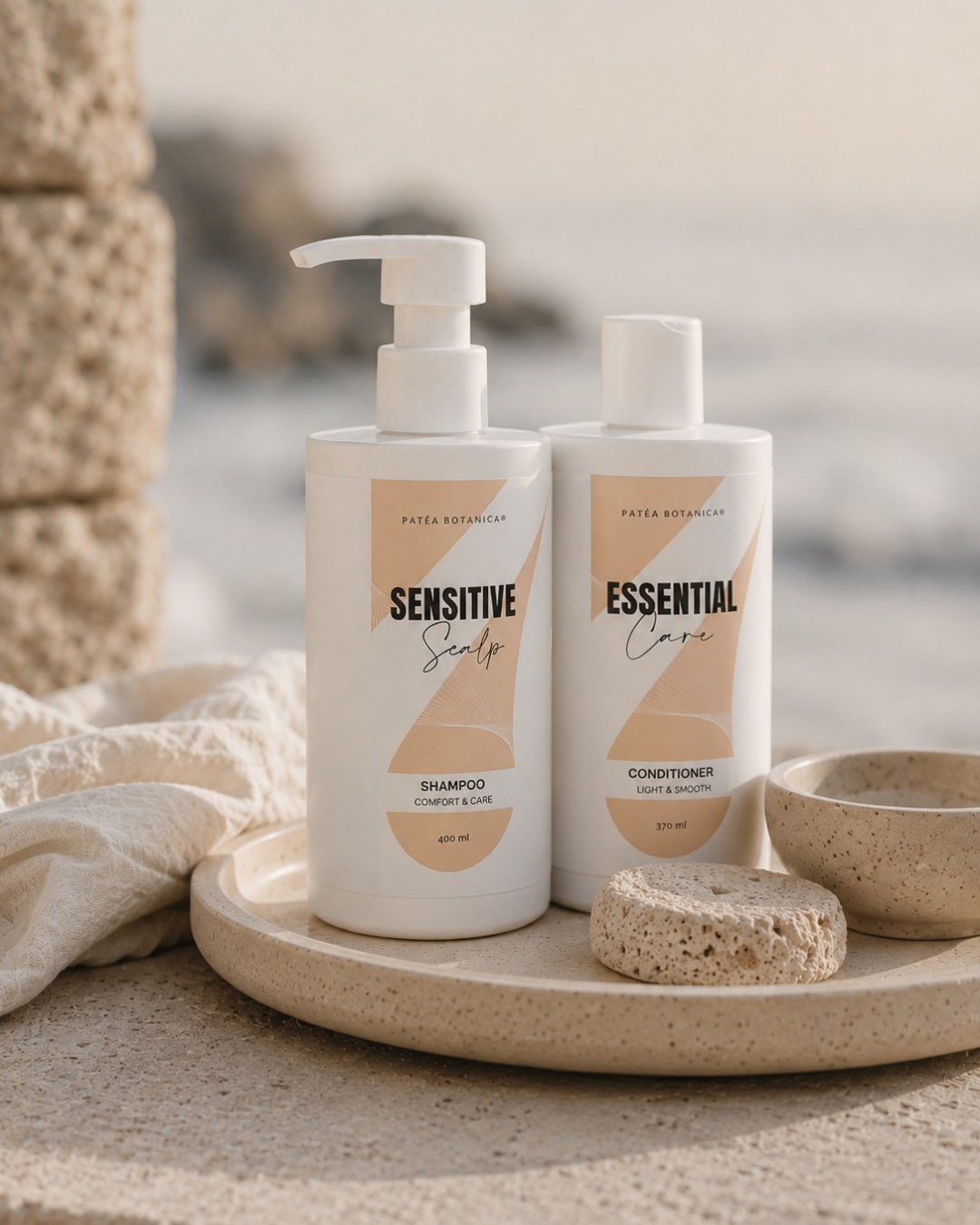 Two bottles of sensitive haircare Patea Botanica products on a stone surface with a natural background.